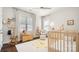 Neutral-toned Bedroom with wood crib, plush toys, and hardwood floors at 1446 Downs Ave, Charlotte, NC 28205