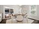 Elegant dining room with a round wood table, stylish chairs, a modern light fixture, and access to the porch at 1446 Downs Ave, Charlotte, NC 28205