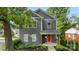 Beautiful gray two-story house with a vibrant red front door, complemented by lush greenery at 1446 Downs Ave, Charlotte, NC 28205