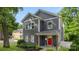 Charming two-story home with gray siding, a bright red door, and a welcoming front porch at 1446 Downs Ave, Charlotte, NC 28205