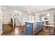 Bright open kitchen with a blue island, hardwood floors, and access to the living areas at 1446 Downs Ave, Charlotte, NC 28205