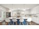 Bright kitchen features a large island with seating, stainless appliances, white cabinets, and a tiled backsplash at 1446 Downs Ave, Charlotte, NC 28205