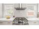 Close-up of a stainless steel range with white tile backsplash and marble countertops at 1446 Downs Ave, Charlotte, NC 28205