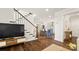 Inviting living room with hardwood floors, staircase and kitchen access at 1446 Downs Ave, Charlotte, NC 28205
