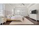Tranquil main bedroom featuring a tray ceiling, rocking chair, and white linens at 1446 Downs Ave, Charlotte, NC 28205