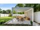 Inviting outdoor patio featuring a pergola, dining table, lounge seating, and string lights for perfect entertaining at 1446 Downs Ave, Charlotte, NC 28205