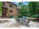 Backyard featuring a pool, patio with dining and mature trees at 1500 Tarrington Way, Wesley Chapel, NC 28079