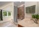 Bathroom featuring a tiled shower, vanity with sink, and a window with a view of the greenery outside at 1500 Tarrington Way, Wesley Chapel, NC 28079