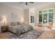 Spacious primary bedroom with high ceilings, natural light, and a cozy seating area at 1500 Tarrington Way, Wesley Chapel, NC 28079