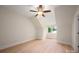 Cozy bedroom featuring neutral walls, hardwood flooring, and a bright window providing ample natural light at 1500 Tarrington Way, Wesley Chapel, NC 28079