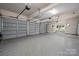 Spacious three-car garage with epoxy floors and storage shelves at 1500 Tarrington Way, Wesley Chapel, NC 28079