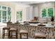 Stylish kitchen island with bar seating, custom leaf-patterned design, and modern lighting fixtures at 1500 Tarrington Way, Wesley Chapel, NC 28079