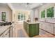 Bright kitchen with stainless steel appliances, custom cabinetry, and center island with barstools at 1500 Tarrington Way, Wesley Chapel, NC 28079