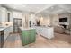 Modern kitchen with stainless steel appliances, large island, and open layout to the living area at 1500 Tarrington Way, Wesley Chapel, NC 28079