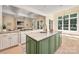 Spacious kitchen featuring an island with a sink, granite counters, and lots of natural light at 1500 Tarrington Way, Wesley Chapel, NC 28079