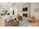Inviting living room featuring a stone fireplace, coffered ceilings, and comfortable seating area at 1500 Tarrington Way, Wesley Chapel, NC 28079
