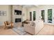Cozy living room features fireplace with stone surround and access to outdoor balcony at 1500 Tarrington Way, Wesley Chapel, NC 28079