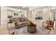 Bright, open living room featuring hardwood floors and seamless flow into the kitchen area at 1500 Tarrington Way, Wesley Chapel, NC 28079
