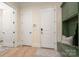 Hallway with doors and a built-in mudroom bench and storage at 1500 Tarrington Way, Wesley Chapel, NC 28079
