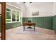 Well-lit home office with wainscoting, hardwood floors, and a large window at 1500 Tarrington Way, Wesley Chapel, NC 28079