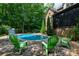 Backyard pool with slide and seating surrounded by beautiful greenery at 1500 Tarrington Way, Wesley Chapel, NC 28079