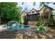 Backyard pool, slide, with lounge seating by the covered patio area at 1500 Tarrington Way, Wesley Chapel, NC 28079