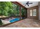 A beautiful covered porch overlooks a sparkling pool, perfect for outdoor relaxation and entertainment at 1500 Tarrington Way, Wesley Chapel, NC 28079