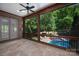Relaxing screened porch offering views of the sparkling pool and lush backyard at 1500 Tarrington Way, Wesley Chapel, NC 28079