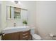 Modern powder room with a floating vanity, stylish mirror, and neutral decor at 1500 Tarrington Way, Wesley Chapel, NC 28079