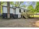 Backyard view of home with a chimney, back door, deck, and concrete parking at 1739 16Th Ne St, Hickory, NC 28601