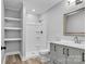 Bathroom features a shower, vanity with sink, and open shelving at 1739 16Th Ne St, Hickory, NC 28601