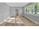 A bright and airy bedroom with wood-look floors and a view of the neighborhood at 1739 16Th Ne St, Hickory, NC 28601