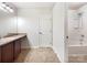 Bathroom featuring a single vanity, a large mirror, and a separate shower-tub combo at 178 Wellshire St, Mooresville, NC 28115