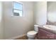 A half bathroom features a vanity sink and neutral walls with a window at 178 Wellshire St, Mooresville, NC 28115