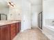 Modern bathroom with double vanity, soaking tub, and a glass-enclosed shower for a spa-like experience at 178 Wellshire St, Mooresville, NC 28115