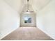 Well-lit bedroom with neutral carpet, vaulted ceilings, and a ceiling fan for comfortable living at 178 Wellshire St, Mooresville, NC 28115