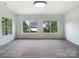 Bedroom with natural light showcasing neutral carpet and large windows providing outdoor views at 178 Wellshire St, Mooresville, NC 28115