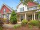 Charming two-story home featuring a well-manicured lawn, lush landscaping, and inviting entrance at 178 Wellshire St, Mooresville, NC 28115