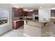 A stylish kitchen featuring dark cabinets, granite countertops, and modern stainless steel appliances at 178 Wellshire St, Mooresville, NC 28115