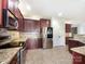 Well-appointed kitchen featuring stainless steel appliances, granite countertops, and cherry wood cabinets at 178 Wellshire St, Mooresville, NC 28115