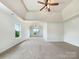 Bright carpeted main bedroom showcasing a vaulted ceiling and a ceiling fan with overhead lighting at 178 Wellshire St, Mooresville, NC 28115