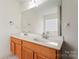 Bathroom featuring a double sink, granite countertop, and large mirror at 1911 Savannah Hills Dr, Matthews, NC 28105