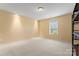 Empty bedroom featuring neutral walls and carpet, a window and ample space at 1911 Savannah Hills Dr, Matthews, NC 28105