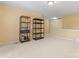 Open, spacious bonus room with neutral carpet and storage shelving at 1911 Savannah Hills Dr, Matthews, NC 28105