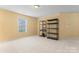Large bonus room with shelving units and a window allowing for natural light at 1911 Savannah Hills Dr, Matthews, NC 28105