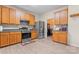 Functional kitchen boasts oak cabinets, stainless steel appliances, and modern flooring for a practical design at 1911 Savannah Hills Dr, Matthews, NC 28105