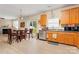 Open kitchen with wood cabinetry, stainless steel appliances, and a sliding glass door at 1911 Savannah Hills Dr, Matthews, NC 28105