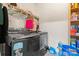 A well-equipped laundry room with modern washer, dryer, storage and cleaning supplies at 1911 Savannah Hills Dr, Matthews, NC 28105
