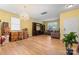 Expansive living room with wood-look floors, a chandelier, large TV console, and comfortable sofa at 1911 Savannah Hills Dr, Matthews, NC 28105