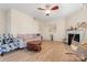 Inviting living room featuring a ceiling fan, cozy fireplace, and stylish furniture at 1911 Savannah Hills Dr, Matthews, NC 28105